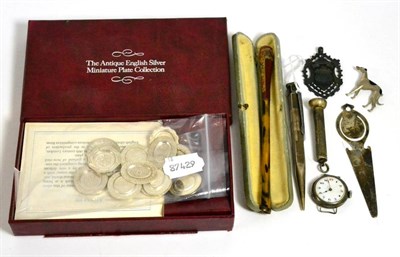 Lot 173 - A silver cigar piercer, medallion, pen, wristwatch, bookmark, a set of miniature silver plates etc
