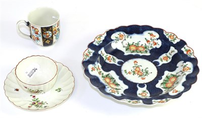 Lot 199 - A Worcester blue scale ground porcelain plate, circa 1775, painted with Kakiemon flowers, 21cm...