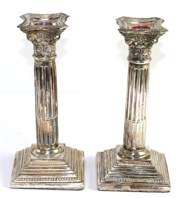 Lot 204 - A pair of silver Corinthian column candlesticks (weighted)