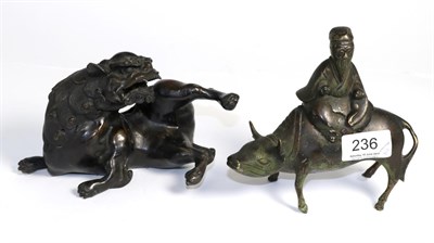 Lot 236 - Two Chinese bronze figures, of Immortal on water buffalo and of Lion dog