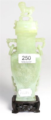 Lot 250 - A jade type vase in archaic style, the lid surmounted by a dog of foe, 23cm high