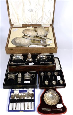 Lot 257 - A group of cased silver including shell form butter dish and knife, two sets of coffee spoons,...