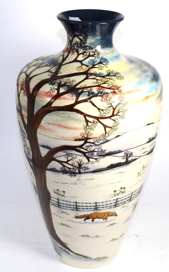 Lot 276 - A large Moorcroft pottery vase, Winter landscape design, original box