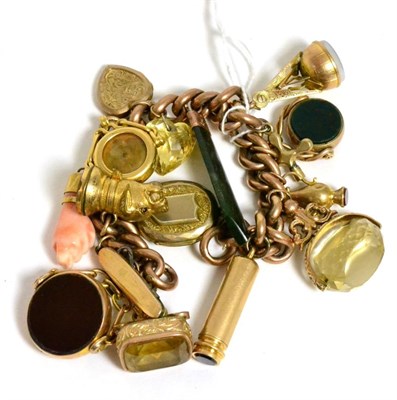 Lot 296 - A charm bracelet set with sixteen charms including fobs
