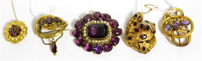 Lot 313 - A Victorian garnet set brooch, two gilt metal garnet set brooches, and two purple paste set...