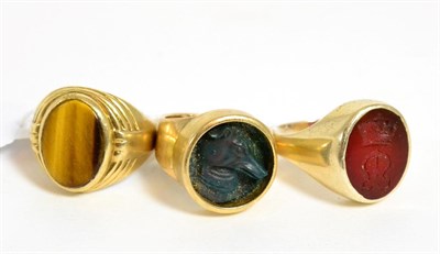 Lot 332 - Three 9ct gold signet rings, two with carved hard stone matrix (3)