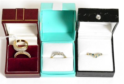 Lot 337 - A diamond three stone ring, a 9ct gold sapphire and diamond wishbone ring, a 9ct gold cubic...