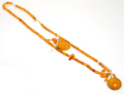 Lot 338 - An amber necklace, two pairs of amber earrings and two amber brooches