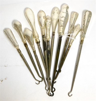Lot 420 - Eleven assorted silver mounted button hooks, each with Neo Classical decoration to the handles, the