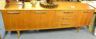 Lot 1097 - A 1960's teak sideboard, a teak extending dining table, two single chairs, an angle poise lamp...