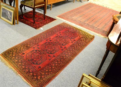 Lot 1102 - Pakistani Bukhara carpet, the terracotta field of four rows of guls enclosed by multiple...