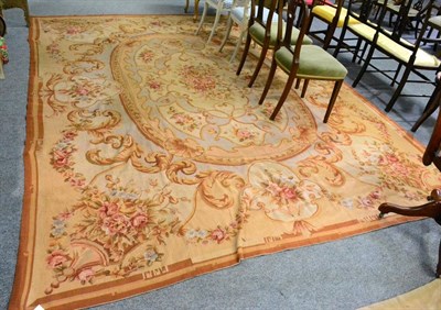 Lot 1104 - A French style needlepoint carpet, China, the central oval panel with naturalistic floral...