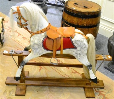 Lot 1111 - Carved and painted wood rocking horse on trestle base
