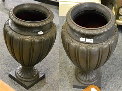 Lot 1121 - A pair of cast iron urn shaped vases