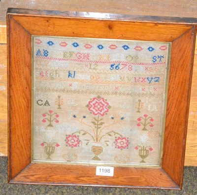 Lot 1198 - Victorian alphabet sampler worked by Isabella Anderson, aged 13, dated 1859, with central vase...