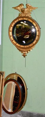 Lot 1209 - An oval gilt framed wall mirror and a mahogany Edwardian oval wall mirror (2)