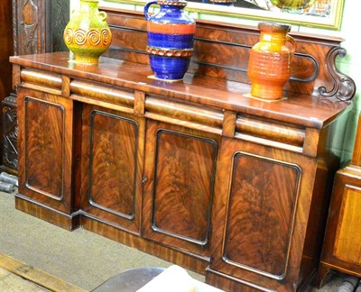 Lot 1215 - A Victorian mahogany sideboard with three drawers above cupboards below