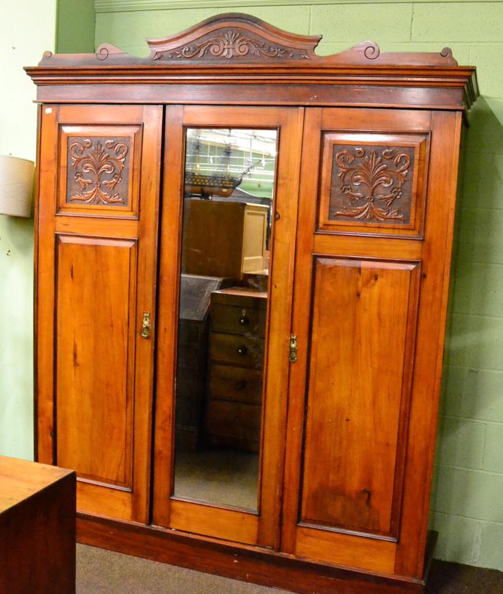 Lot 1230 - An early 20th century mirror fronted triple wardrobe