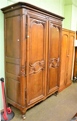 Lot 1233 - A large 19th century French armoire with carved panel doors