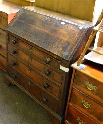 Lot 1238 - A George III oak and mahogany cross banded bureau