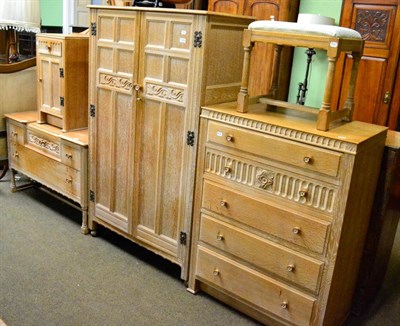 Lot 1240 - A five piece limed oak bedroom suite comprising wardrobe, dressing table, chest of drawers, bedside