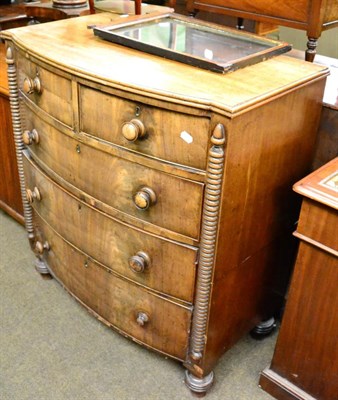 Lot 1255 - A bow fronted mahogany four height chest of drawers with bun handles, in two sections