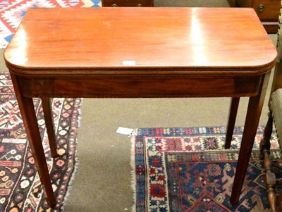 Lot 1269 - A 19th century mahogany D shaped fold over tea table with ebony stringing