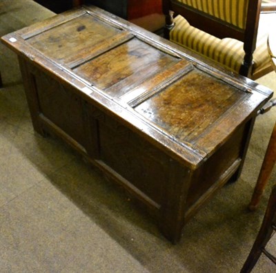 Lot 1277 - A panelled oak coffer with carved front