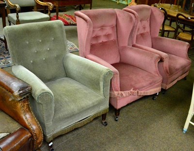 Lot 1284 - A pair of upholstered wing back armchairs together with another upholstered armchair
