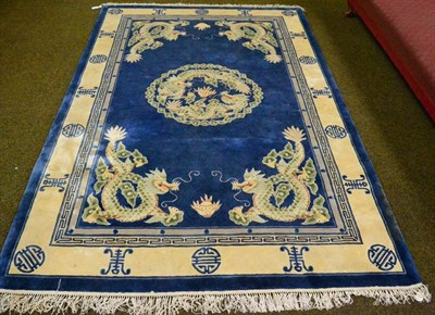 Lot 1296 - A Chinese superwash carved rug, the mid blue field with dragons chasing flaming pearls enclosed...