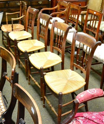 Lot 1302 - A set of four French spindle back rush seated chairs together with a rush seat armchair with...