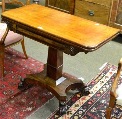 Lot 1309 - An early Victorian mahogany fold over table on pedestal support