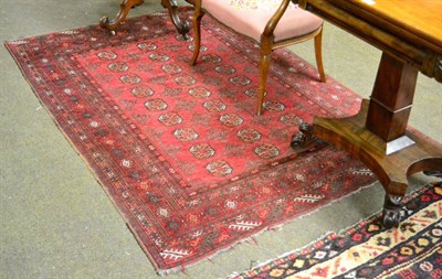 Lot 1311 - Afghan rug, the raspberry field with three rows of guls enclosed by narrow borders, 180cm by 128cm