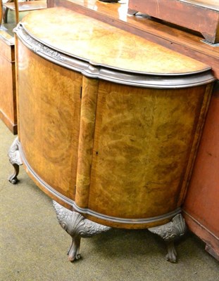 Lot 1323 - A 20th century walnut demi-lune cabinet