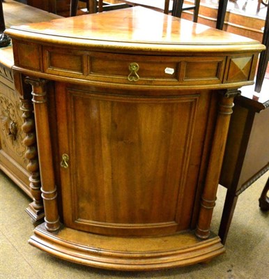 Lot 1330 - A mahogany corner cabinet with bowed door and twin pillar supports
