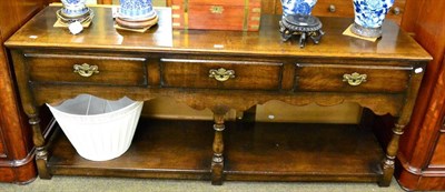 Lot 1353 - An reproduction oak dresser base by Titchmarsh & Goodwin, fitted with three drawers above...