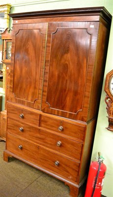 Lot 1356 - A Georgian mahogany linen press on bracket feet, the interior with slide out trays