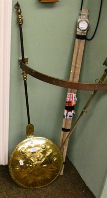 Lot 1367 - A 17th century Dutch brass warming pan, embossed and engraved with stylized flowers, 110cm high