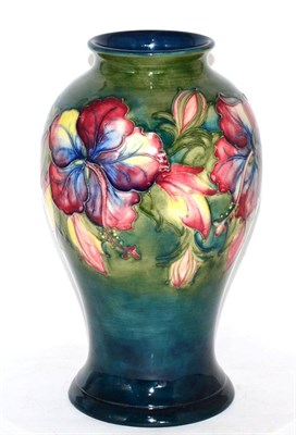 Lot 44 - A Walter Moorcroft pottery baluster vase, Hibiscus pattern, painted and impressed marks and...