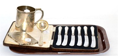 Lot 48 - A group of silver comprising a Christening mug, card case, Scottish sauce ladle and a set of...