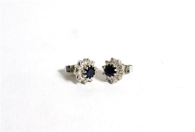 Lot 102 - A pair of 18 carat white gold sapphire and diamond stud earrings