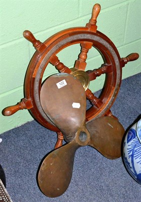 Lot 122 - A brass mounted teak ships wheel and bronze ship propeller