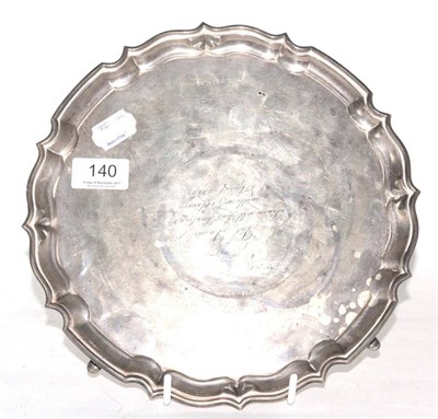 Lot 140 - A George V silver salver, Birmingham 1934, with presentation inscription, pie crust rim and...