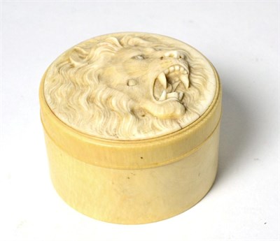 Lot 141 - A 19th century Japanese carved ivory box, the cover depicting a roaring lion