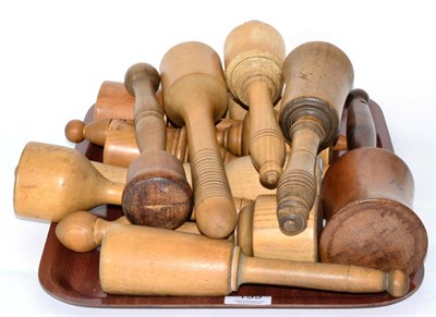 Lot 199 - A group of fourteen 19th century turned wood pestles, pounders and mashers (2 trays)