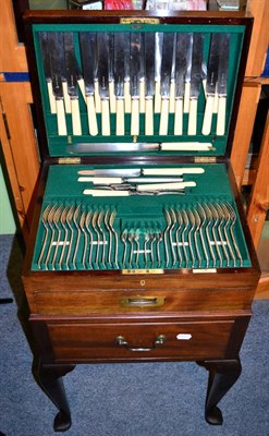 Lot 248 - A mahogany canteen on stand complete with flatware service for twelve place settings