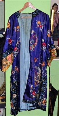 Lot 252 - Chinese blue silk robe embroidered with dragons and floral designs