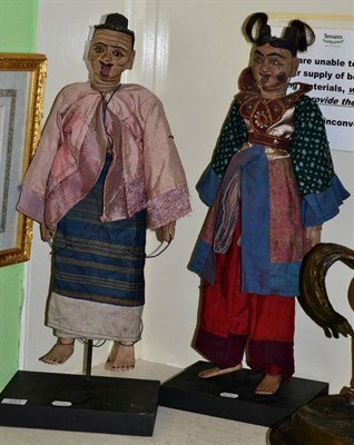 Lot 253 - A pair of Burmese articulated wood comedy puppets, the female character with articulated breasts