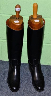 Lot 259 - A pair of black leather riding boots with wood trees