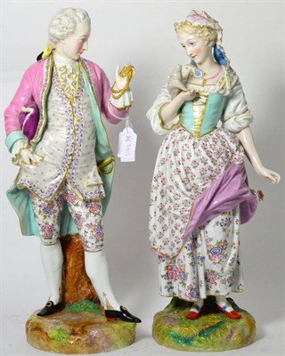 Lot 324 - A pair of continental porcelain figures of a lady and gentleman, circa 1880, wearing romantic...